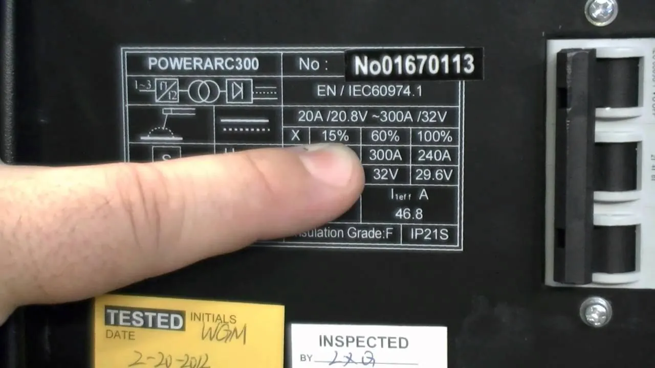 Close-up of a welding machine data plate showing amperage ratings for welder duty cycle.