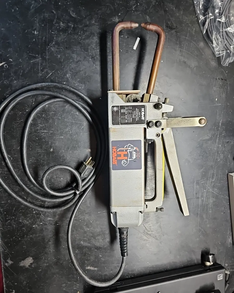 Inside a portable welder showing transformer, circuit board and cooling fan