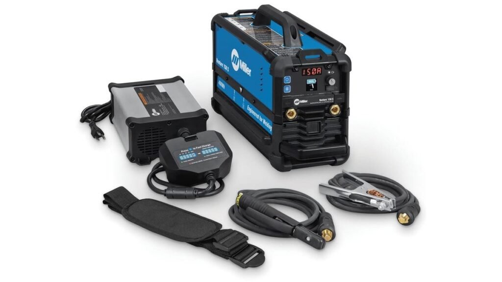 Portable cordless welder on a workshop bench with helmet and gloves