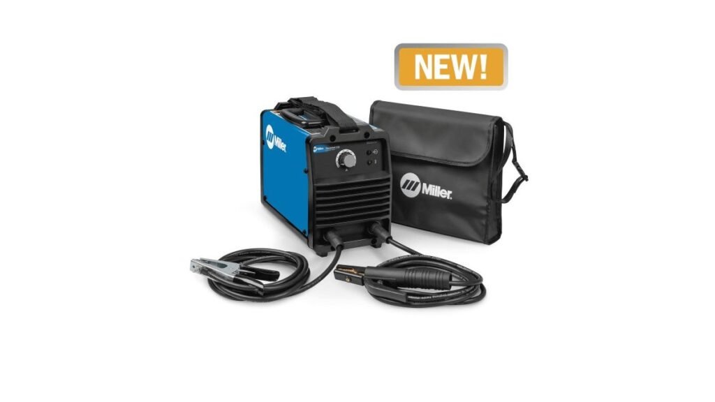 Portable stick welder with cables on a concrete workshop floor in daylight