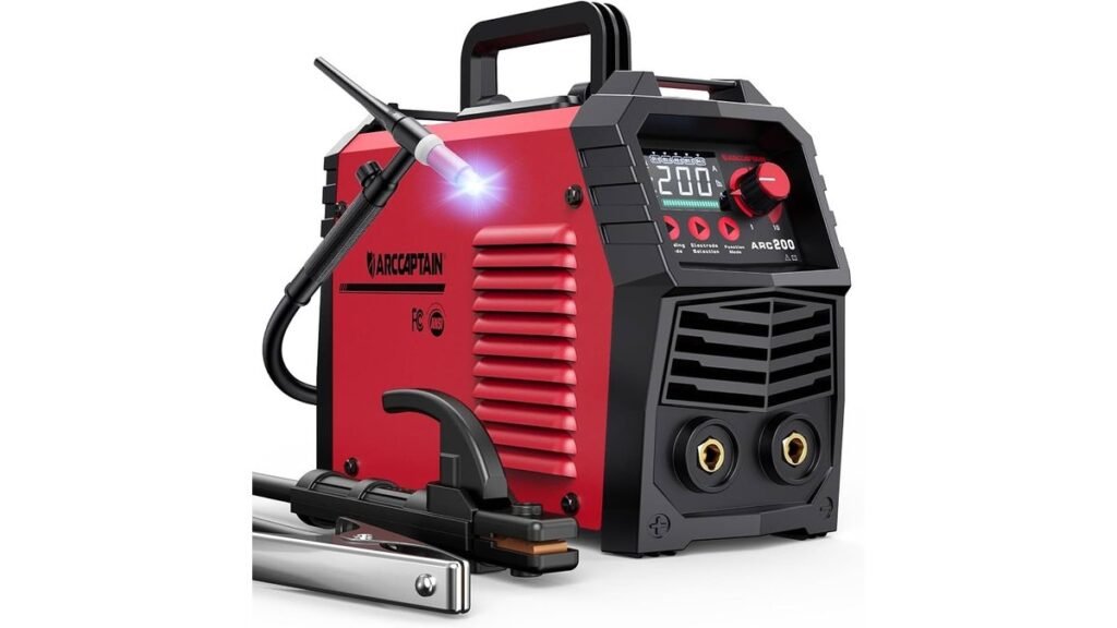 Portable TIG welder on a workshop bench beside stainless steel and a helmet