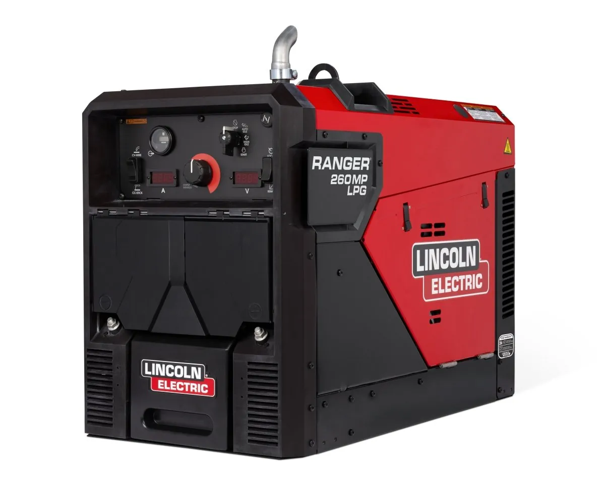 Portable welder with flux-core wire and gloves on a workbench